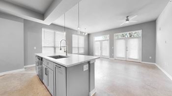 An empty kitchen with an island in the middle of it